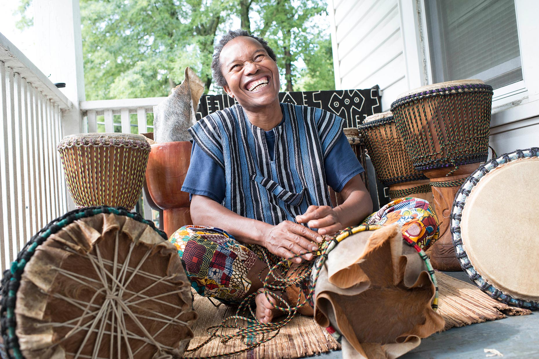 Braima Moiwai on his Durham Porch. Moiwai is a teacher, a musician, a drummaker and a bright, lovely soul.